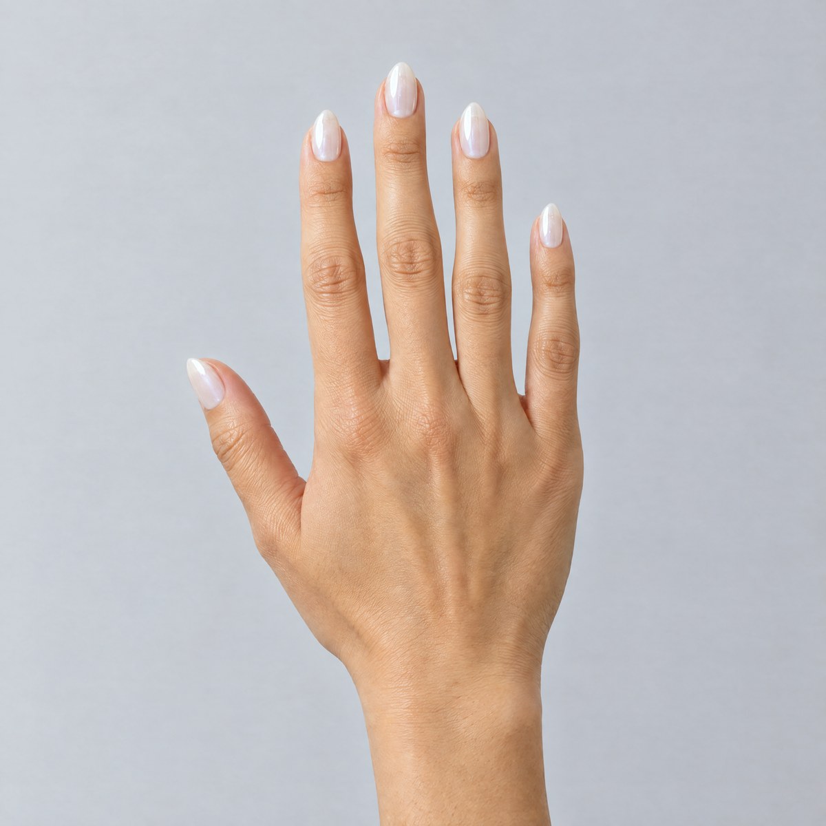The same hand wearing milky white short almond Nailees press-on nails